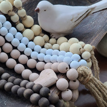 Load image into Gallery viewer, A simple must have coffee table styling piece, these wooden beads add a touch of feel-good style to your living space. Inspired by Mala beads used for prayer and meditation, they encourage mindfulness, peace, and clarity. Dimensions: 48"L x 0.5"W x 0.5"H Materials: Paulownia Wood, Jute rope tassels - Carved from paulownia wood and finished with a white wash
