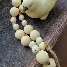 Load image into Gallery viewer, A simple must have coffee table styling piece, these wooden beads add a touch of feel-good style to your living space. Inspired by Mala beads used for prayer and meditation, they encourage mindfulness, peace, and clarity. Dimensions: 36"L x 1"W x 1"H Materials: Paulownia Wood, Jute rope - Carved from paulownia wood and finished with a natural wash