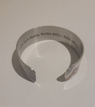 Load image into Gallery viewer, We have picked some of our favourite pieces and paired them with an inspirational saying that resonates with us.  Quote inside:  "Life is a story. Write well. Edit often."  Made of aluminum each cuff is hypo-allergenic, lead and nickel free, with no toxic finishes. Everything is printed with a permanent dye which gives a nice vibrant finish.   Cuffs are super light weight and adjustable allowing them to be molded to fit most sizes. Think....fancy slap bracelet from the 80s.  Each cuff is 3/4" thick