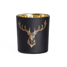 Load image into Gallery viewer, This beautiful Silhouette Glass Votive brings the timeless elegance of black and gold together with the iconic silhouette of the noble staghead. This piece is the perfect accent to any home, office, or cottage and makes a great addition to your holiday decorations. Add ambience to your room with a tealight, or place on a shelf or table and fill with a pre-potted plant or florals for a lively display. Size: 3" H x 3"D Handwash *Includes (1) tealight
