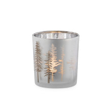 Load image into Gallery viewer, This beautiful Silhouette Glass Votive brings the timeless elegance of the majestic tall gold pines etched in a silver frosted glass.  A stylish accent to any home, office, or cottage and makes a great addition to your holiday decorations.  Add ambience to your room with a tealight.  Perfect for warming up any room or as a centerpiece for seasonal events.  Size:  3" H x 3"D  Handwash  *Includes (1) tealight