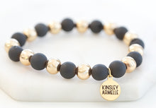 Load image into Gallery viewer, The Luxor Geode Beaded Bracelet in Black and Gold is comprised of geode pocks on the surface of stone beads. Geodes are known to have hollow cavities lined with crystals. Silver frost mark the perimeter of this piece to give it the perfect druzy shine. Try stacking these with other bracelets to really bring it all together. Exclusively from Kinsley Armelle. Details: Style: Beaded Material: Agate + Metal Size: 6.5 - 8 Inch Circumference