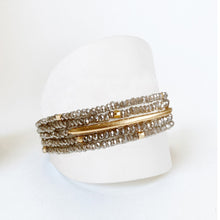 Load image into Gallery viewer, It doesn't get more versatile than this.  This exquisite accessory is a one of a kind "must have" piece that you will wear over and over again.  As a bracelet or as a necklace, this beautiful grey glass beaded with gold adornment single strand accessory will look stunning with any outfit.  Details:  One Size Fits Most Glass beads Gold plated adornments Nickel/lead free 3 coats anti-tarnish