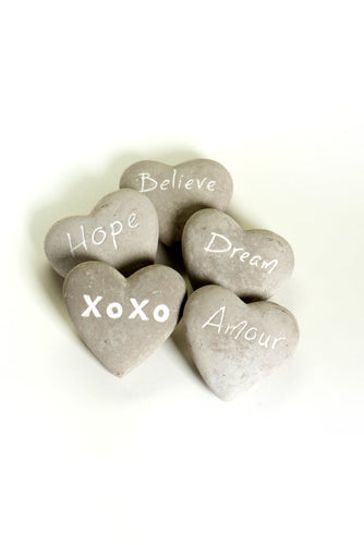 These fun and sentimental heart shaped stones are perfect for expressing ones feelings of love, hope, dream and belief.  Comes in an assorted set of 5.  Give all 5 to that special someone, or spread the love and give one to all your special someones.  Don't forget to keep one as a reminder to yourself.   Each Set Includes 5 Stones*:  Believe Hope Dream Amour XOXO Materials: Cement   Dimensions: 2.7
