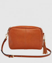 Load image into Gallery viewer, This Tan Holly crossbody bag is the ultimate accessory.   Stylish, yet practical.  Great for travel and you will be amazed at how much fits in there.  Features:  1 Zip Pocket 1 Flat Pocket Internal lining - Black/White Stripe Strap: 110cm Adjustable Detachable Closure: Zip Closure Material: Suedette Vegan Leather  Hardware: Light Gold  Dimensions: W24 x H16 x D8 cm