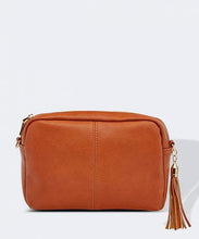 Load image into Gallery viewer, This Tan Holly crossbody bag is the ultimate accessory.   Stylish, yet practical.  Great for travel and you will be amazed at how much fits in there.  Features:  1 Zip Pocket 1 Flat Pocket Internal lining - Black/White Stripe Strap: 110cm Adjustable Detachable Closure: Zip Closure Material: Suedette Vegan Leather  Hardware: Light Gold  Dimensions: W24 x H16 x D8 cm