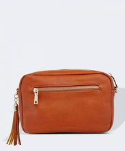 Load image into Gallery viewer, This Tan Holly crossbody bag is the ultimate accessory.   Stylish, yet practical.  Great for travel and you will be amazed at how much fits in there.  Features:  1 Zip Pocket 1 Flat Pocket Internal lining - Black/White Stripe Strap: 110cm Adjustable Detachable Closure: Zip Closure Material: Suedette Vegan Leather  Hardware: Light Gold  Dimensions: W24 x H16 x D8 cm