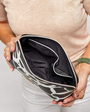 Load image into Gallery viewer, The Bardot Swirl Case is a funky, black and white art print case with a firm structure so it stands tall in your bathroom.  Perfect as a make-up or toiletry case for those weekend getaways.  It's Rose Gold zippr is a beautiful additional detail.  Pair it with the Emma Hanging Toiletry case for an Exclusive Bundle!  Internal Features:  2 Flat Pockets Lining: Polyester Sateen Twill Secure Zip Material: Vegan Leather  Hardware: Rose Gold  Dimensions: H18.5 x W26 x D9 cm. Shown: Inside Bardot Case