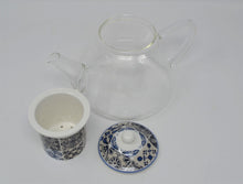 Load image into Gallery viewer, This is a classic glass teapot with the added beautiful detail of a blue mosaic porcelain infuser and lid.  Gorgeous for any breakfast or brunch table, this teapot will make the perfect cup of loose leaf tea.  Pair it with our beautiful collection of cups and teas for an ultimate Birthday, Mother's Day, Hostess or Just Because gift.  Size:  23oz capacity  Material:  Glass/Ceramic
