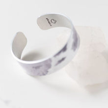 Load image into Gallery viewer, We have picked some of our favourite pieces and paired them with an inspirational saying that resonates with us. Quote inside: "Life is a story. Write well. Edit often." Made of aluminum each cuff is hypo-allergenic, lead and nickel free, with no toxic finishes. Everything is printed with a permanent dye which gives a nice vibrant finish. Cuffs are super light weight and adjustable allowing them to be molded to fit most sizes. Each cuff is 3/4" thick