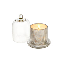 Load image into Gallery viewer, Made from a lovely clear glass with a rounded knob, this cloche allows the beauty of the candle's design to been seen while preserving its scent, and protecting the candle from dust or damage, helping them last longer. Features a beautiful Amber Spruce scent of wintergreen, and eucalyptus leaves. LENGTH: 3.25 WIDTH: 3.25 HEIGHT: 4.50 Shown: Lit Silver Cloche