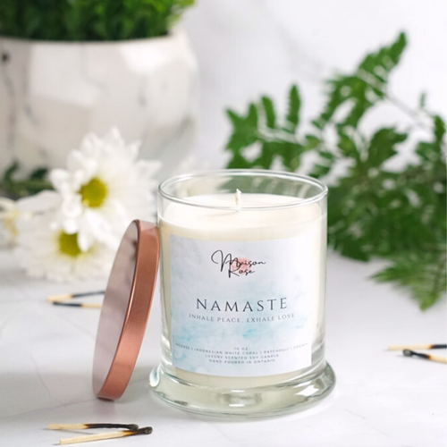 Relax and center yourself when feeling out of balance with the Namaste Candle.  Key Ingredients: Incense, Indonesian White Copal, Patchouli, Champa Aroma: Smokey, Aromatic, Herbal Type of Product: Hand-poured soy candle Size: 10 oz  Burning Time: 60+ hours Made With: A natural soy wax  A natural wax coated cotton wick for fast fragrance release  Premium scented candles Paraffin-free, phthalate-free essential and fragrance oils,  100% vegan,  Packaged in a reusable apothecary jar with a rose gold lid