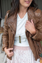 Load image into Gallery viewer, The Angelica layered necklace has golden copper tones pattern reminiscent of a cathedral frieze.  The off centre bend allows for the affirmation word "Serenity" to be exposed.  This is the perfect layering necklace with a 30" stainless steel, hypo-allergenic, tarnish free chain and a recycled aluminum pendant.  The pendant measures 3 1/4" long x 3/4" wide. The aluminum makes it light weight for easy wear. Shown:  Person wearing Angelica necklace