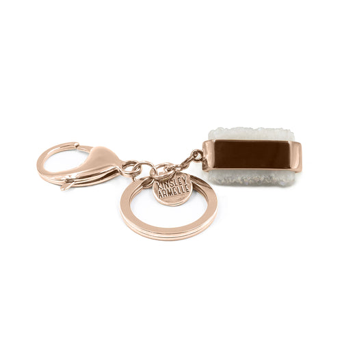 This Quartz Bangle Keychain features dual raw quartz stones on a smooth rose gold ion-plated stainless steel pendant. The stones are rigid rocks to add that extra flare to your style. Exclusively from Kinsley Armelle.   Details:  Material: 18K Rose Gold Ion Plated Stainless Steel Size: 3 Inch Long