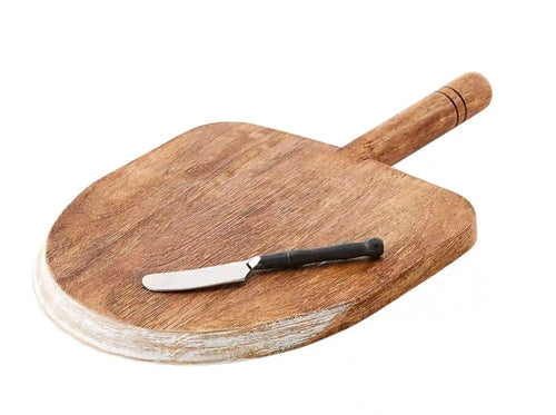 Serve up your favourite cheeses and bread with this gorgeous Mango Wood Paddle Serving Board Set.  The paddle board features a cut edge detail and will definitely compliment any table. Makes a great hostess, bridal shower or seasonal gift. Set Includes: (1) Mango Wood Board (1) Cast Iron Handle Spreader Size:  Board - 14.25 x 9