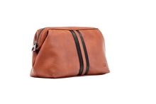 Load image into Gallery viewer, The Gilbert Men’s Toiletry Case is the perfect men’s travel accessory. Designed to fit his toiletries with ease and constructed with quality vegan leather, it is an ideal gift for the men in your life. 2 Colours to choose from: Black Tan Pair it with the Sinatra Toiletry Case for a set that has him covered! Internal features: 1 Zip Pocket Lining: Nylon Closure: Secure Zip Material: Vegan Leather Hardware: Gun Metal Dimensions: W25.5 x H16.5 x D9cm. Shown: Tan