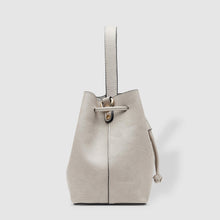 Load image into Gallery viewer, Complete with a drawstring closure, the Sasha is perfect for your next brunch with the girls, or a day out on the town.  Wear it your way and sling over your shoulder for a more casual look or carry by her top handle for a dressier option.  Features:  1 Slip Pocket Internal lining - Vegan Leather Extension strap: 114-128cm Adjustable Detachable Closure: Magnetic Clasp with Draw String Material: Vegan Leather  Hardware: Light Gold  Dimensions: W26 x H23 x D14 cm