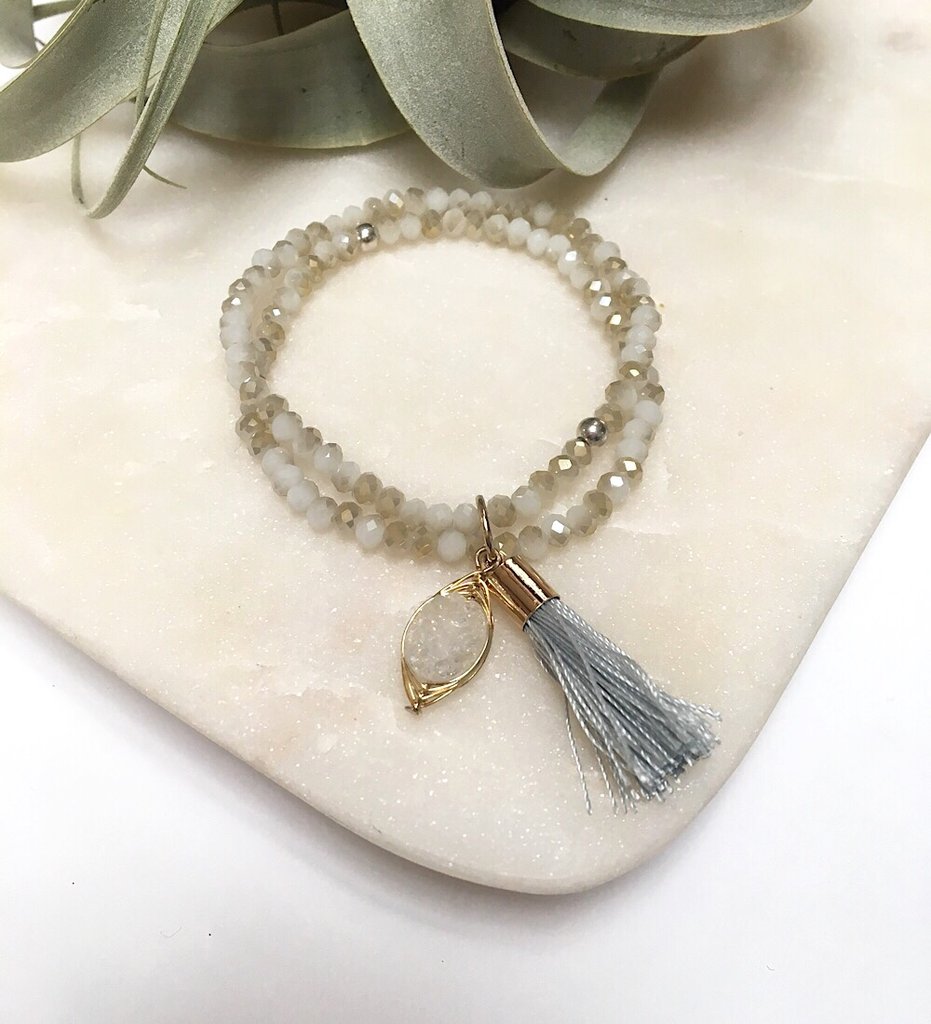 There is no such thing as too many sparkly crystals or flowing tassels - so adorn your wrists with as many of these bracelets as you desire for that ultimate layered look.  Details:  Swarovski crystal beads  Wire-wrapped druzy charm 1.5