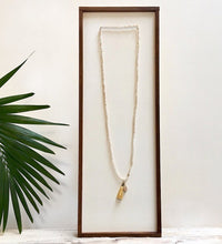 Load image into Gallery viewer, There is no such thing as too many pieces of jewelry, especially sparkly ones with flowing tassels.  Adorn your neck with the latest layered look.  *Paired in picture with the Triptych Necklace  Details:  Swarovski crystal beads strung on elastic Wire-wrapped druzy charm 1.5&quot; tassel 35&quot; in length Hypoallergenic Nickel/lead free 3 coats anti-tarnish. Shown: Champagne Necklace
