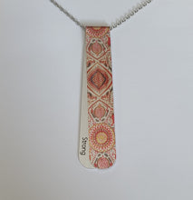 Load image into Gallery viewer, The Caraway necklace has a vintage middle eastern vibrant pattern, with hits of warm green and ochre.  The off centre bend allows for the affirmation word &quot;Strong&quot; to be exposed.  This is the perfect layering necklace with a 30&quot; stainless steel, hypo-allergenic, tarnish free chain and a recycled aluminum pendant.  The pendant measures 3 1/4&quot; long x 3/4&quot; wide. The aluminum makes it light weight for easy wear.
