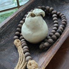 Load image into Gallery viewer, A simple must have coffee table styling piece, these wooden beads add a touch of feel-good style to your living space. Inspired by Mala beads used for prayer and meditation, they encourage mindfulness, peace, and clarity. Dimensions: 48&quot;L x 0.5&quot;W x 0.5&quot;H Materials: Paulownia Wood, Jute rope tassels - Carved from paulownia wood and finished with a brown wash
