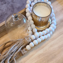 Load image into Gallery viewer, A simple must have coffee table styling piece, these wooden beads add a touch of feel-good style to your living space. Inspired by Mala beads used for prayer and meditation, they encourage mindfulness, peace, and clarity. Dimensions: 48&quot;L x 0.5&quot;W x 0.5&quot;H Materials: Paulownia Wood, Jute rope tassels - Carved from paulownia wood and finished with a white wash
