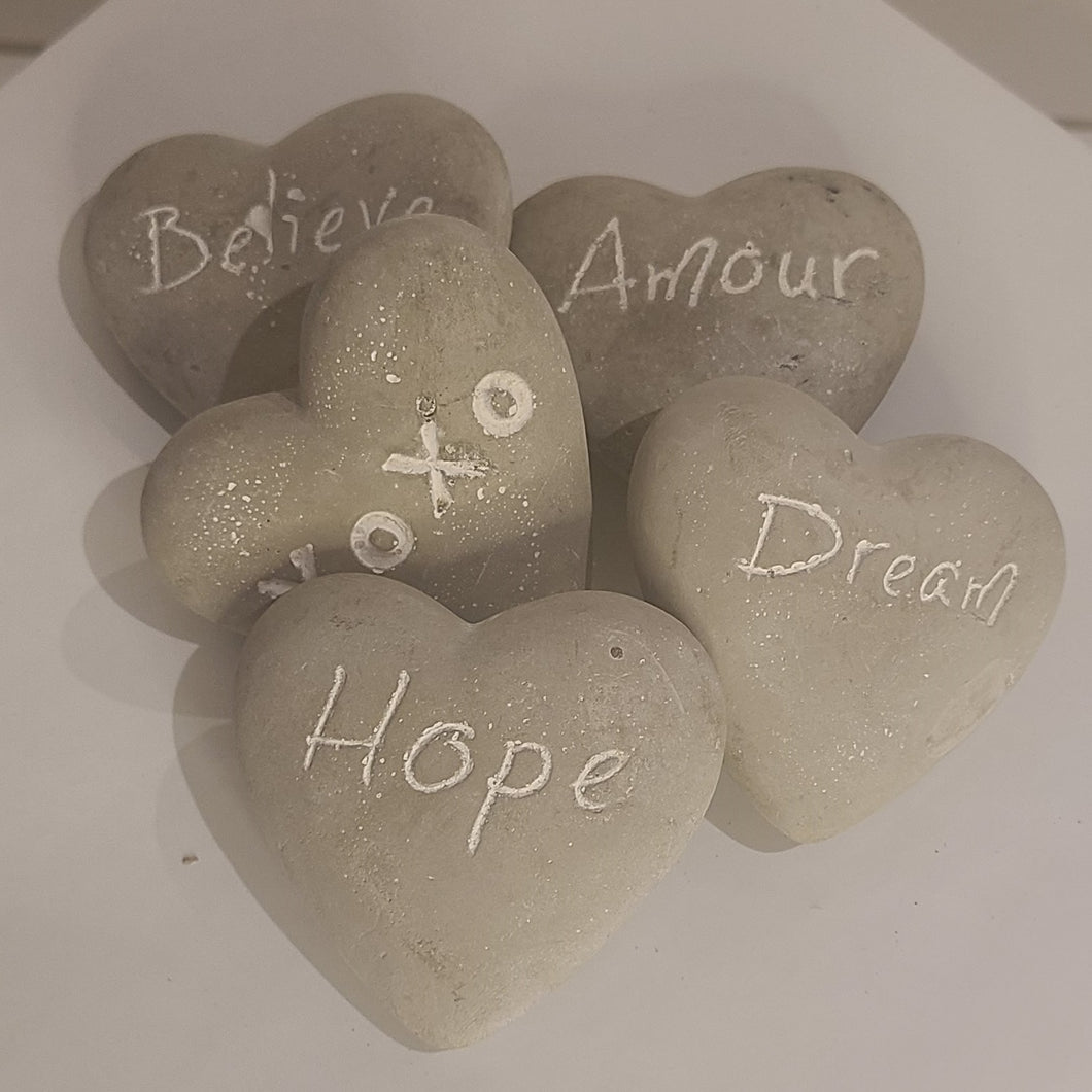 These fun and sentimental heart shaped stones are perfect for expressing ones feelings of love, hope, dream and belief. Comes in an assorted set of 5. Give all 5 to that special someone, or spread the love and give one to all your special someones. Don't forget to keep one as a reminder to yourself. Each Set Includes 5 Stones*: Believe Hope Dream Amour XOXO Materials: Cement Dimensions: 2.7