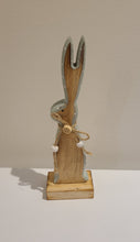 Load image into Gallery viewer, This whymsical wooden bunny makes a fun addition to your Easter decor. The adorable button detail &amp; soft mint painted edge are the perfect complement to any spring mantel, countertop, tabletop or coffee table.  Add it to your Easter gifts for some bunny special.  Size:  2.5 W x 8 H x 1.5 D  Material: Natural Wood
