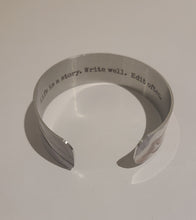 Load image into Gallery viewer, We have picked some of our favourite pieces and paired them with an inspirational saying that resonates with us.  Quote inside:  &quot;Life is a story. Write well. Edit often.&quot;  Made of aluminum each cuff is hypo-allergenic, lead and nickel free, with no toxic finishes. Everything is printed with a permanent dye which gives a nice vibrant finish.   Cuffs are super light weight and adjustable allowing them to be molded to fit most sizes. Think....fancy slap bracelet from the 80s.  Each cuff is 3/4&quot; thick
