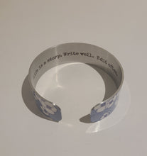 Load image into Gallery viewer, We have picked some of our favourite pieces and paired them with an inspirational saying that resonates with us. We know you will love this piece as much as we do.   Quote inside:  &quot;Life is a story. Write well. Edit often.&quot;  Made of aluminum each cuff is hypo-allergenic, lead and nickel free, with no toxic finishes. Everything is printed with a permanent dye which gives a nice vibrant finish.   Cuffs are super light weight and adjustable allowing them to be molded to fit most sizes.  Each cuff is 3/4&quot; thick
