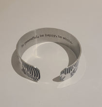 Load image into Gallery viewer, We have picked some of our favourite pieces and paired them with an inspirational saying that resonates with us. We know you will love this piece as much as we do.   Quote inside:  &quot;Be peaceful, be happy, be whole.&quot;  Made of aluminum each cuff is hypo-allergenic, lead and nickel free, with no toxic finishes. Everything is printed with a permanent dye which gives a nice vibrant finish.   Cuffs are super light weight and adjustable allowing them to be molded to fit most sizes.   Each cuff is 3/4&quot; thick
