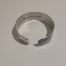 Load image into Gallery viewer, We have picked some of our favourite pieces and paired them with an inspirational saying that resonates with us. Quote inside:  &quot;Life is a story. Write well. Edit often.&quot;  Made of aluminum each cuff is hypo-allergenic, lead and nickel free, with no toxic finishes. Everything is printed with a permanent dye which gives a nice vibrant finish.   Cuffs are super light weight and adjustable allowing them to be molded to fit most sizes.   Each cuff is 3/4&quot; thick
