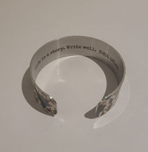 Load image into Gallery viewer, We have picked some of our favourite pieces and paired them with an inspirational saying that resonates with us. We know you will love this piece as much as we do.   Quote inside:  &quot;Life is a story. Write well. Edit often.&quot;  Made of aluminum each cuff is hypo-allergenic, lead and nickel free, with no toxic finishes. Everything is printed with a permanent dye which gives a nice vibrant finish.   Cuffs are super light weight and adjustable allowing them to be molded to fit most sizes.   Each cuff is 3/4&quot; thic
