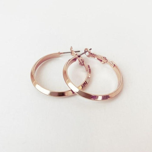 These elegant domed shaped hoops are the perfect size.  Simple and beautiful, for that classy casual look.  Details:  Metallic Rose Gold 1.5