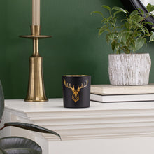 Load image into Gallery viewer, This beautiful Silhouette Glass Votive brings the timeless elegance of black and gold together with the iconic silhouette of the noble staghead. This piece is the perfect accent to any home, office, or cottage and makes a great addition to your holiday decorations.  Add ambience to your room with a tealight, or place on a shelf or table and fill with a pre-potted plant or florals for a lively display.  Size:  3&quot; H x 3&quot;D  Handwash  *Includes (1) tealight
