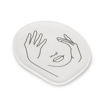 Load image into Gallery viewer, Add an artistic touch to your keepsakes, coins and more with this Face Trinket Plate. Crafted out of porcelain, the subtle Expressionistic lines of a woman’s visage also gives this unique plate its shape. A stylishly unexpected way to store your jewelry or simply keep keys and other knick-knacks close at hand when needed. Will definitely make a statement to any decor. These plates can be used as tea or dessert dishes. Size: Approximately 5 x 4&quot;
