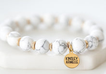 Load image into Gallery viewer, The Pepper Farrah Beaded Bracelet is comprised of White Howlite stone beads spaced evenly with decorative gold embellishment beads. This bracelet is a must have to compliment any outfit, and goes perfectly with other bracelets featured as part of the Lennox Stack. Exclusively from Kinsley Armelle.  Details:  Style: Beaded Material: White Howlite and Metal Size: 6.5 - 7 Inch Circumference
