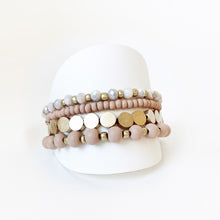 Load image into Gallery viewer, Layered bracelets are all the rage and this sophisticated set is no exception.  Soft and delicate in its appearance, with a mix of painted wood, metal and glass beads, it will definitely become a favourite to wear everywhere with everything.  Details:  Set of 4 as shown One Size Fits Most Nickel/lead free 3 coats anti-tarnish
