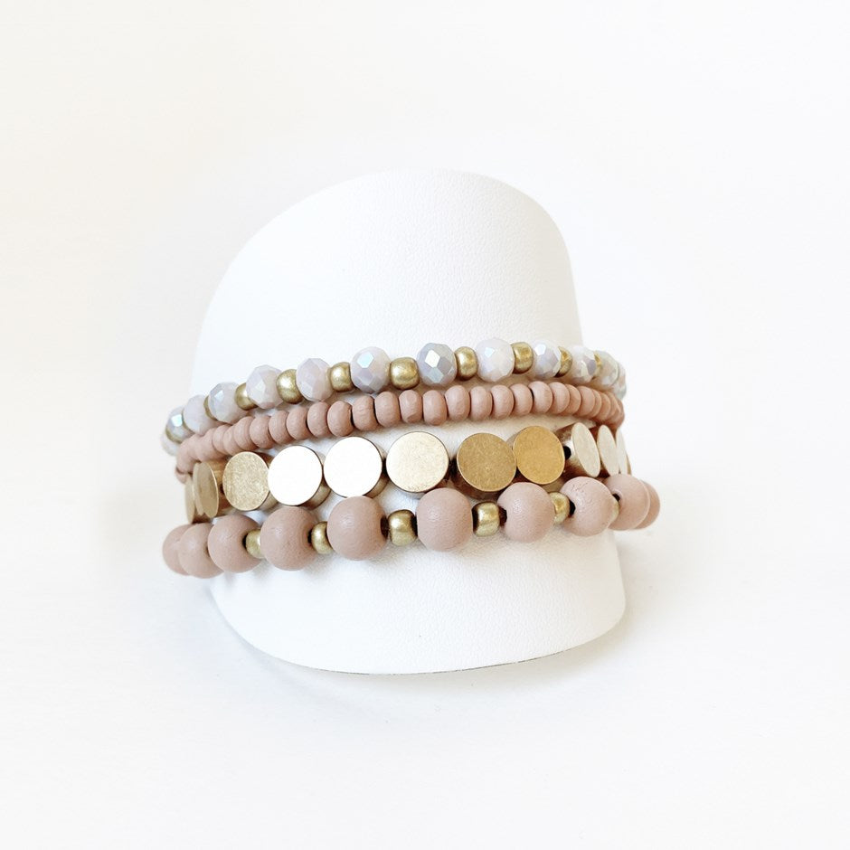 Layered bracelets are all the rage and this sophisticated set is no exception.  Soft and delicate in its appearance, with a mix of painted wood, metal and glass beads, it will definitely become a favourite to wear everywhere with everything.  Details:  Set of 4 as shown One Size Fits Most Nickel/lead free 3 coats anti-tarnish