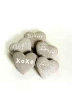 Load image into Gallery viewer, These fun and sentimental heart shaped stones are perfect for expressing ones feelings of love, hope, dream and belief.  Comes in an assorted set of 5.  Give all 5 to that special someone, or spread the love and give one to all your special someones.  Don&#39;t forget to keep one as a reminder to yourself.   Each Set Includes 5 Stones*:  Believe Hope Dream Amour XOXO Materials: Cement   Dimensions: 2.7&quot;L x 2.5&quot;W (each stone)  Fragile in nature; handle with care  *Must be purchased as a set of 5 assorted stones.
