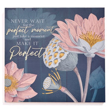 Load image into Gallery viewer, Dress up your walls with these gorgeous decorative plaques.  Styled with metallic gold accents and beautiful sentimental messages.  Perfect for home offices, family rooms or foyers.  Make great gifts for any occassion.  Two Styles Available:  Blue - NEVER WAIT FOR THE PERFECT MOMENT JUST TAKE A MOMENT AND MAKE IT PERFECT Pink - HAPPINESS WILL NEVER COME TO THOSE WHO FAIL TO APPRECIATE WHAT THEY ALREADY HAVE. Size:  13.5&quot; x 13.5&quot; x 0.9&quot;  Material:  MDF/Paper
