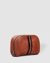 Load image into Gallery viewer, The Sinatra Men’s Toiletry Case is a great men’s travel accessory. Designed to fit just the essentials, his toiletries will be organized, and compact with this travel cases’ four elasticated slip pockets and mesh zip pocket.2 Colours to choose from: Black Tan Pair it with the Gilbert Toiletry Case for a set that has him covered! Features: 4 Elastic Slip Pockets 1 Mesh Zip Pocket Lining: Nylon Closure: Secure Zip Material: Vegan Leather Hardware: Gun Metal W22 x H14 x D5cm. Shown: Tan
