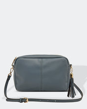 Load image into Gallery viewer, This Storm Blue Holly crossbody bag is the ultimate accessory.   Stylish, yet practical.  Great for travel and you will be amazed at how much fits in there.  Features:  1 Zip Pocket 1 Flat Pocket Internal lining - Black/White Stripe Strap: 110cm Adjustable Detachable Closure: Zip Closure Material: Suedette Vegan Leather  Hardware: Silver  Dimensions: W24 x H16 x D8 cm
