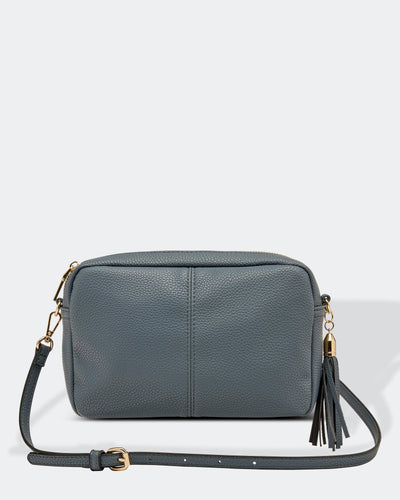 This Storm Blue Holly crossbody bag is the ultimate accessory.   Stylish, yet practical.  Great for travel and you will be amazed at how much fits in there.  Features:  1 Zip Pocket 1 Flat Pocket Internal lining - Black/White Stripe Strap: 110cm Adjustable Detachable Closure: Zip Closure Material: Suedette Vegan Leather  Hardware: Silver  Dimensions: W24 x H16 x D8 cm