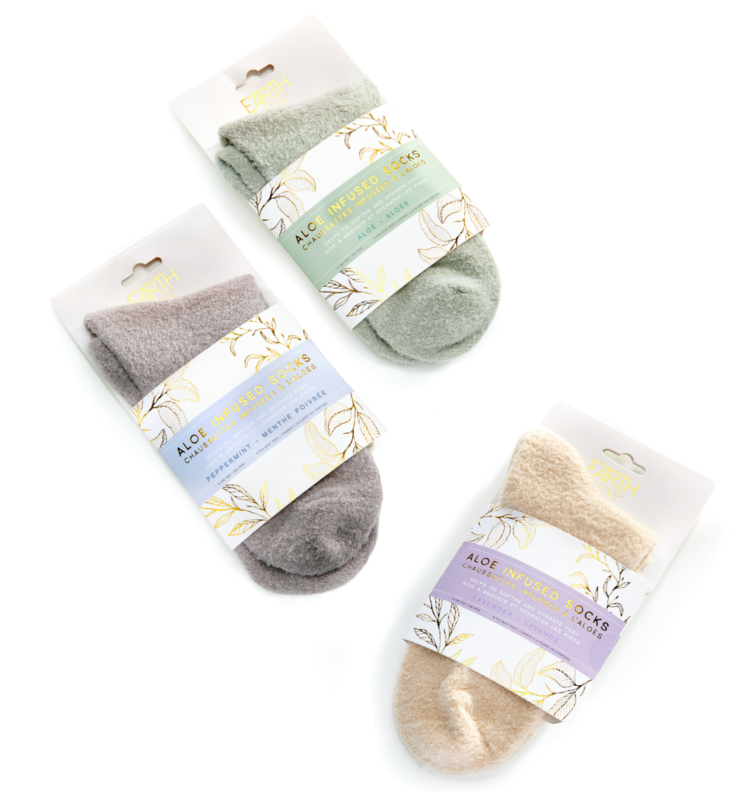 Soothe and comfort feet with these soft socks infused with moisturizing aloe vera and essential oil fragrances. With a luxurious feel and relaxing scent, these socks are perfect for pulling on after a long day.  3 Scents to Choose from:  Lavender Peppermint Aloe Nylon, Polyester, Spandex. One size fits most. Machine Washable.