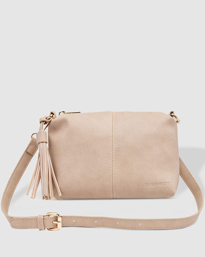 The Baby Daisy Putty Crossbody is a small, unstructured body style bag, with a relaxed look and tassel detail for some fun and spark.  It's just the right size and feels so soft.  For travel or work, throw Baby Daisy in your larger tote and be ready for anything.  Features:  1 x Zip Pocket 2 x Flat Pockets Internal lining - Black/White Stripe Extension strap: 110cm Adjustable Detachable Closure: Secure Zip Material: Vegan Leather  Hardware: Light Gold  Dimensions: W25 x H16 x D6 cm