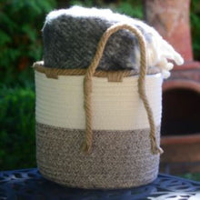 Load image into Gallery viewer, Medium woven braided basket - 9.5&quot; diameter. Shown with wool blanket inside
