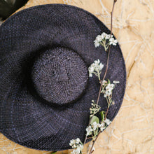 Load image into Gallery viewer, Hat is handmade by skilled Indonesian artisans. This Beach Hat is wide-brimmed, floppy, breathable and lightweight. It will keep its shape while being bendable to your preferred style, and easy to care for. You can add colour to your hat by adding a sash, or a lightweight scarf above the brim. Very versatile. One-size-fits-many. Pair it with our beach bags and pareo for the cottage or beach. Size: 21&quot; diameter, one size fits many Material: 100% Pandanus
