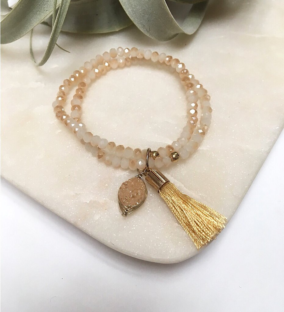 There is no such thing as too many sparkly crystals or flowing tassels - so adorn your wrists with as many of these bracelets as you desire for that ultimate layered look.  Details:  Swarovski crystal beads  Wire-wrapped druzy charm 1.5