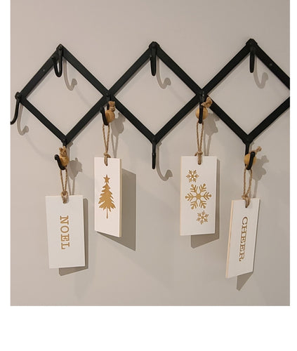 These fun and whymsical Christmas Hangers will create the perfect welcome this holiday season.  With a Christmas Message on one side, and a Winter Symbol on the other, this white and gold decor will look beautiful in any room.  Put it anywhere...doorknobs, walls, mantles...and you can even use it as ornaments on your tree.  2 Styles to choose from:  Cheer Noel. Size:  7.5 x 3.5 x .25